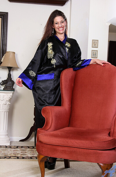 Genivieve drops her robe to reveal sheer lingerie and crotchless tights, then uses a vibrator to make herself cum repeatedly.