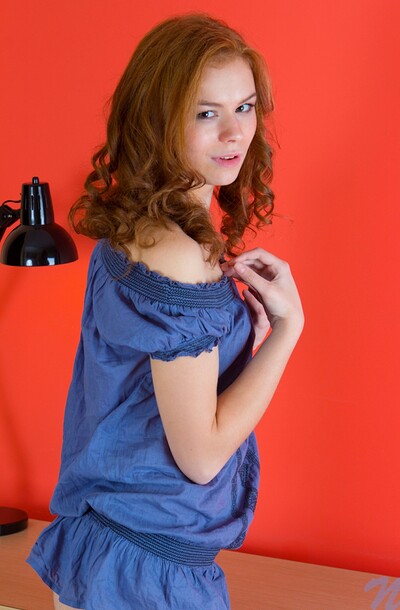 Ksenija, the tantalizing minx with a tousled blue blouse framing her modest assets, seductively undresses to reveal her luscious pale flesh before diving into some serious carnal exploration involving her glistening private bits.