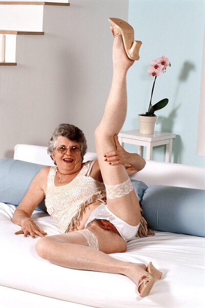 Old lady Carol shows some leg and gives a sensual striptease with her white see-through tights.