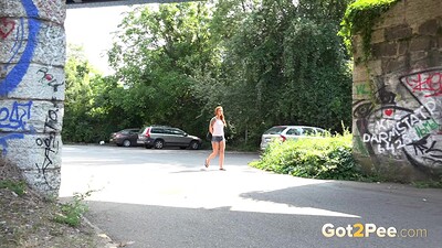 Foxie T in Redhead Squats Outside from 