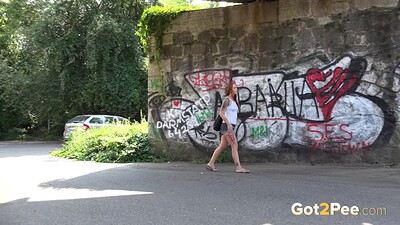 Foxie T in Redhead Squats Outside from 