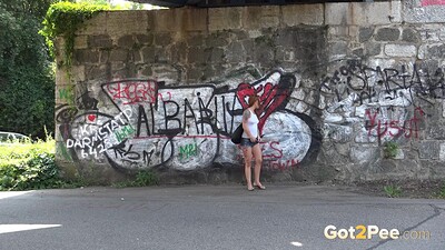 Foxie T in Redhead Squats Outside from 