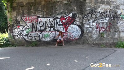 Foxie T in Redhead Squats Outside from 