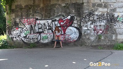 Foxie T in Redhead Squats Outside from 