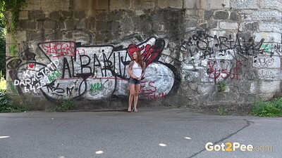 Foxie T in Redhead Squats Outside from 