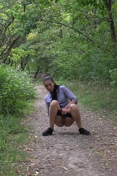 Esperansa squats on the path, pulling down her hotpants to urgently spray her messy pee stream onto the ground.