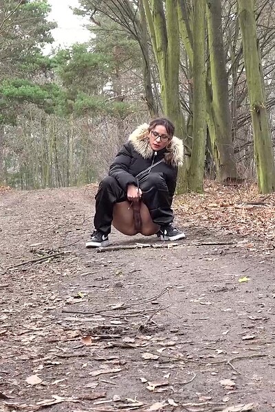 Natasha Ink squats low in the woods, her hairy pussy on full display as she pisses desperately.
