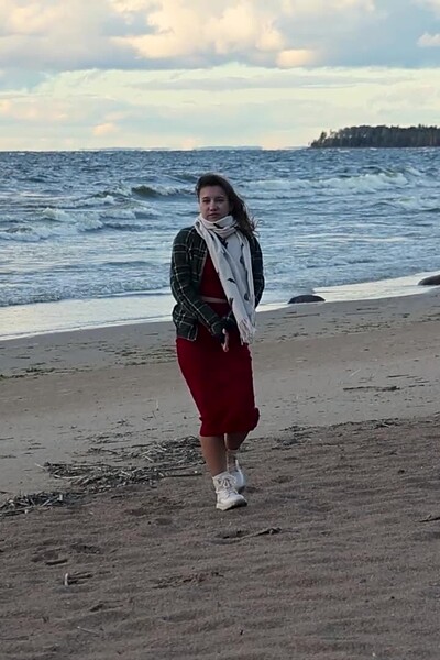 A gorgeous brunette lifts her red skirt, pulls off her panties, and is filmed pissing with her legs wide apart as the wind blows her stream back toward her face.