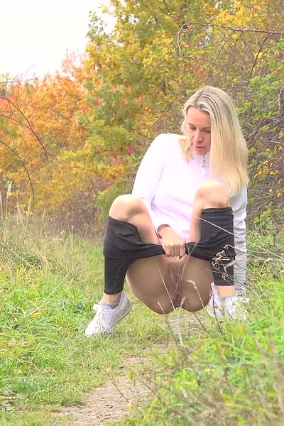Bianca squats and pisses while being filmed.