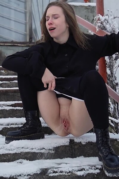 Alice Klay squats on the snow-covered steps, pulling down her pantyhose to desperately pee, her hot stream melting the snow beneath her.