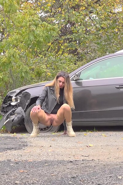 Vanessa Leone squats and pisses a straight stream onto the ground.