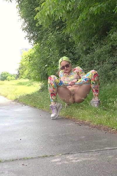 Barbara Bieber squats and gushes her piss onto the ground, making a big puddle.